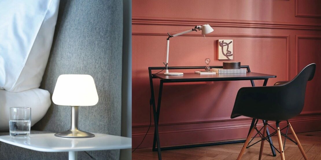 Schlichte Tischleuchte mit Edelstahlfuß und mattem Glasschirm auf einem Nachttisch, moderne Tischleuchte auf einem Schreibtisch